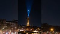 A photo of the moon and a bright star (Venus) above the Eiffel tower in France