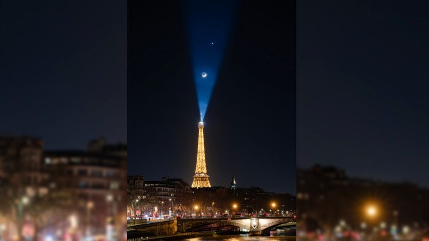 A photo of the moon and a bright star (Venus) above the Eiffel tower in France