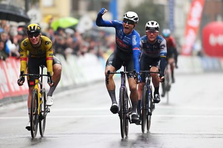 DE PANNE BELGIUM MARCH 22 Jasper Philipsen of Belgium and Team AlpecinDeceuninck celebrates at finish line as race winner ahead of Olav Kooij of The Netherlands and Team JumboVisma L and Yves Lampaert of Belgium and Team Soudal Quick Step R during the 47th Minerva Classic Brugge De Panne 2023 a 211km one day race from Brugge to De Panne on March 22 2023 in De Panne Belgium Photo by Luc ClaessenGetty Images