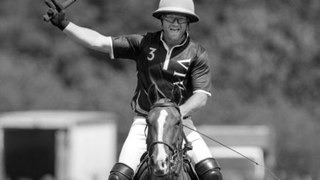 A black and white image of Harry Revell playing polo