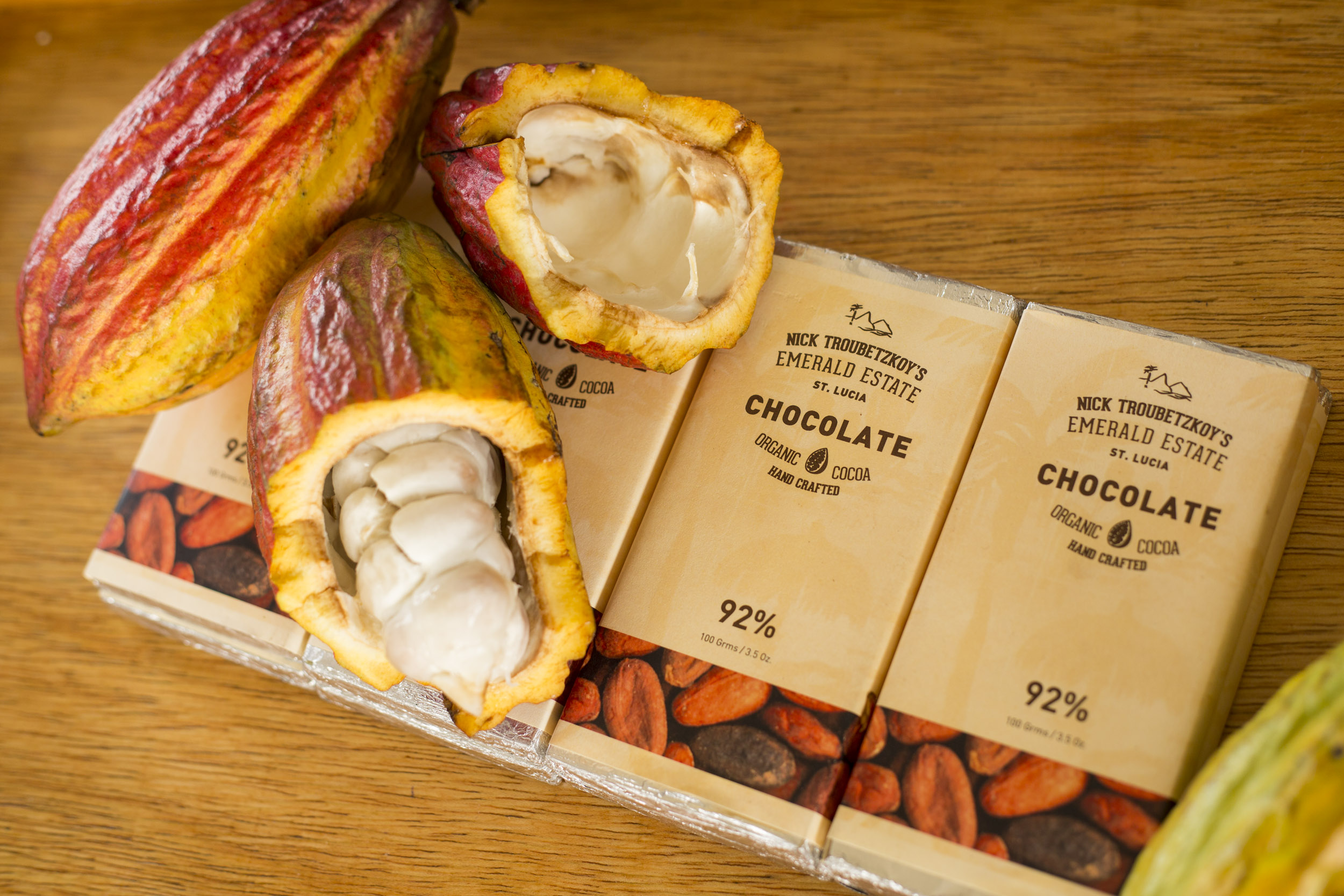 Three chocolate bars made at Jade Mountain Resort with cacao beans on top