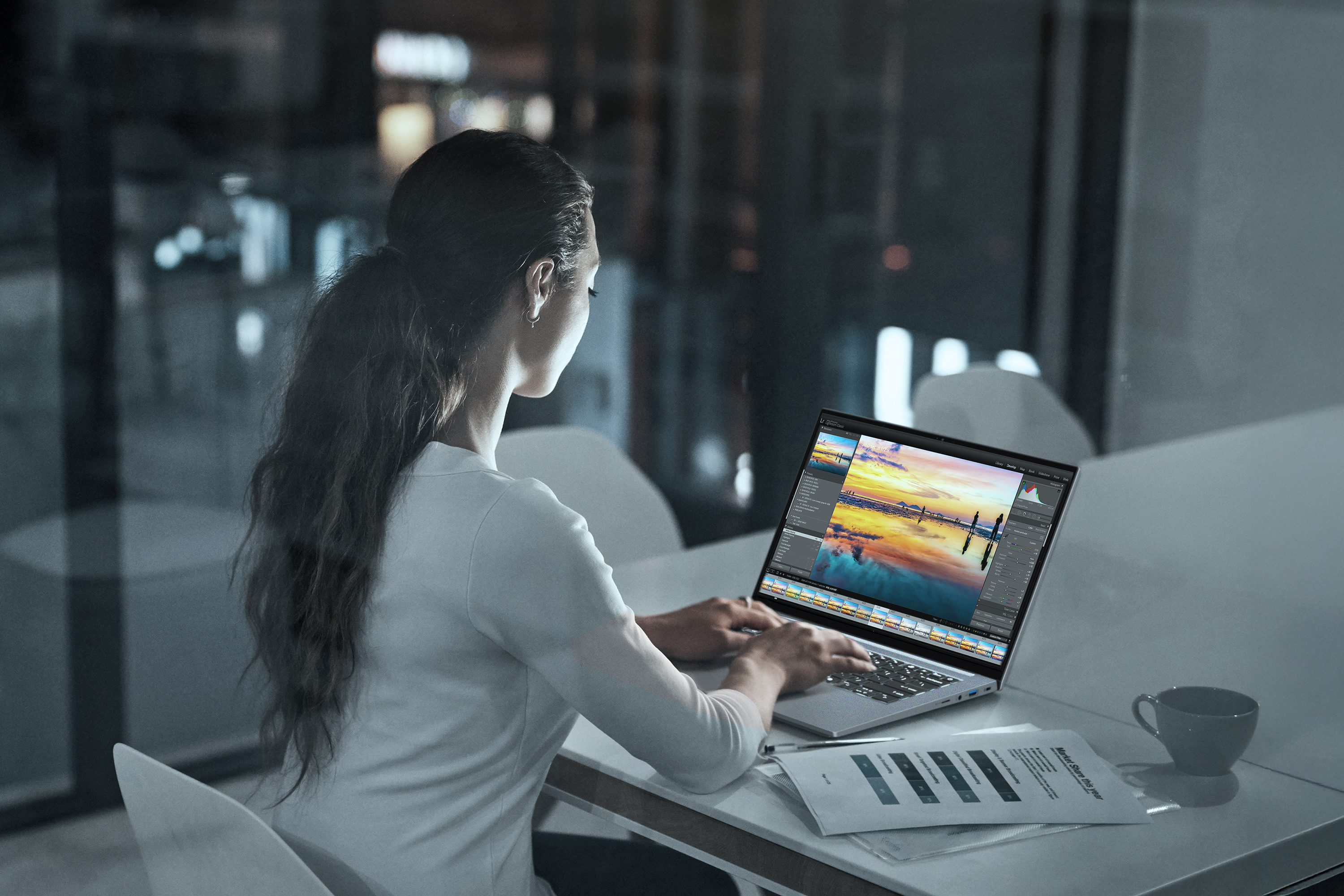 Promotional photo of the Acer Swift X 14 creator laptop being used for video editing in an office.