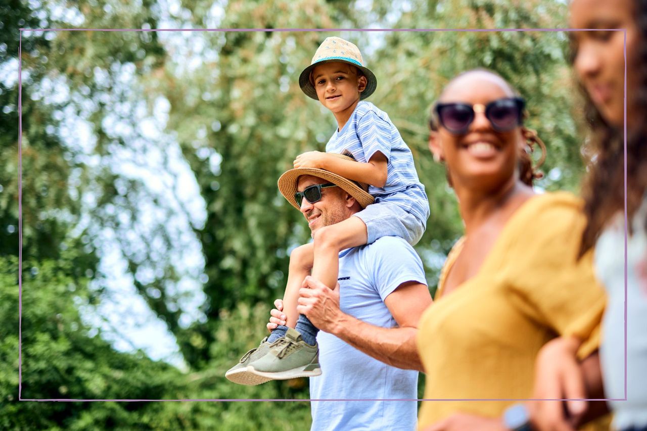 Days out in Kent illustrated by a family walking togeth in a forest with a kid on a man&#039;s shoulders