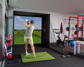 Golf simulator in man cave space with home gym