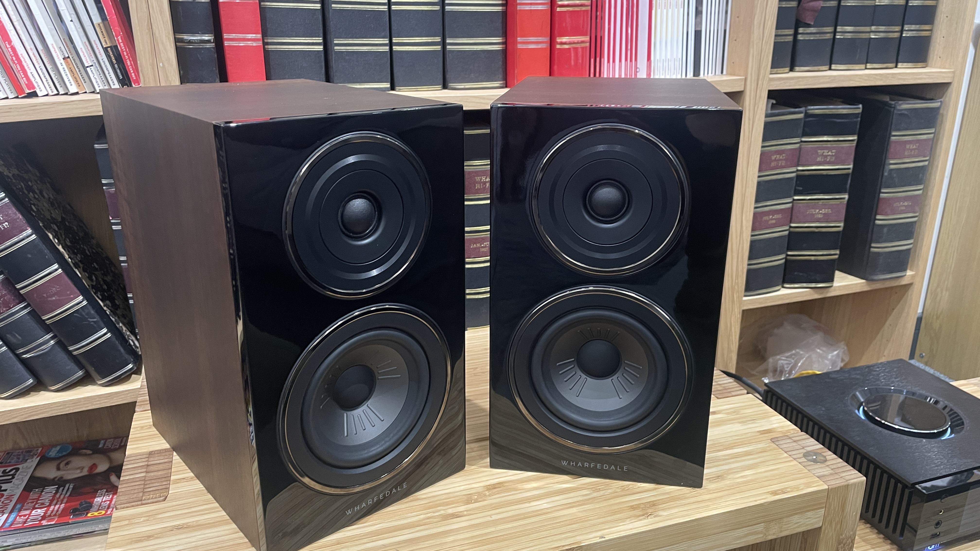 Wharfedale Diamond 12.1 stereo speakers in walnut veneer finish on a wooden rack