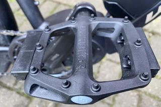 Image shows the DMR V6 flat pedals mounted on a bike