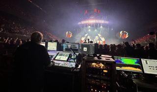 A FOH engineer uses a SSL board to mix a show.