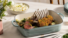 Le Creuset Signature Roaster serving a rack of lamb on a dining table