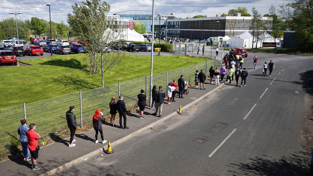 People queue for vaccinations during a spike in the India variant in Bolton