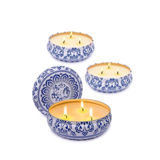 A set of three blue and white three-wick candles