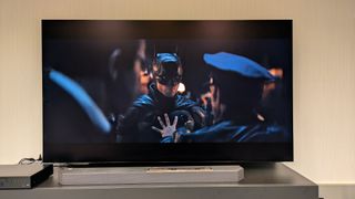 The Samsung S95F TV showing a dark scene from The Batman