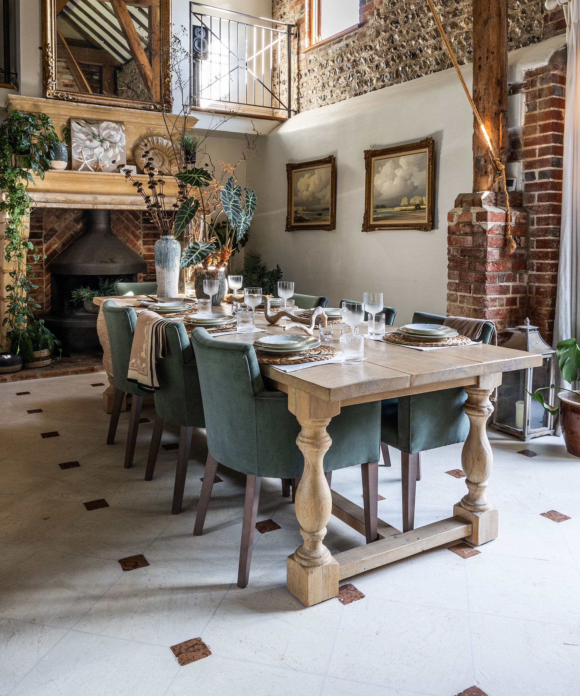 grand double height dining room with tiled floor and open fireplace