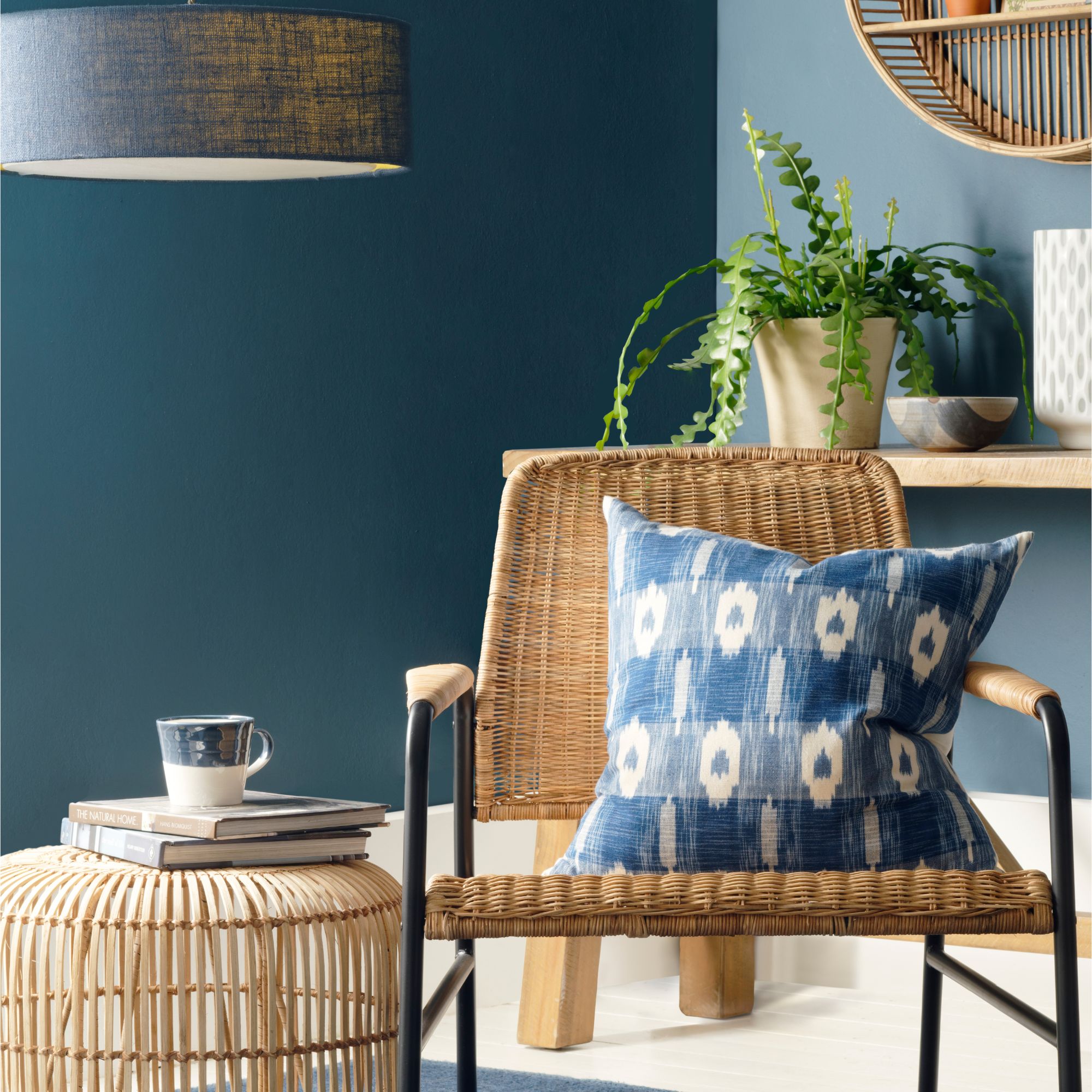 Two-tone blue walls with rattan chair and a blue cushion