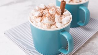 Two mugs of hot chocolate with marshmallows. Hot cocoa in cups. - stock photo