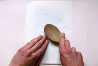 lino printmaking: press down with a wooden spoon