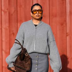 street style shot of woman with glowing skin wearing sunglasses