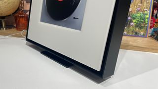 Samsung Music Frame wireless speaker on white surface showing bottom edge of frame