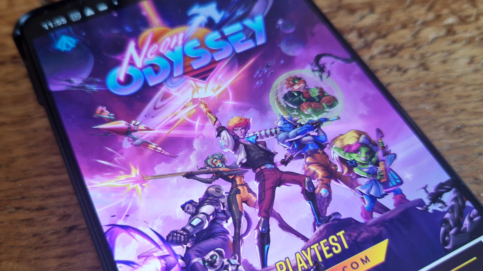 Neon Odyssey playtest cover on a mobile screen, sat on a wooden surface