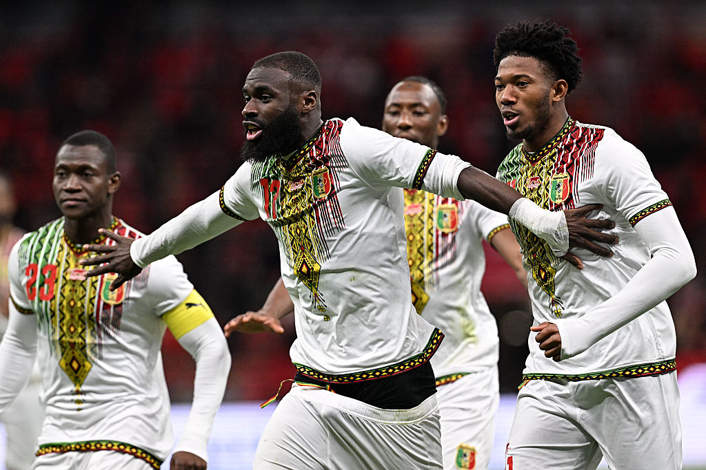 Mali's forward #17 Lassine Sinayoko (C) celebrates scoring the team's first goal from a penalty during the Africa Cup of Nations (CAN) Group A football match between Morocco and Mali at Prince Moulay Abdellah Stadium in Rabat on December 26, 2025. (Photo by Gabriel BOUYS / AFP)
