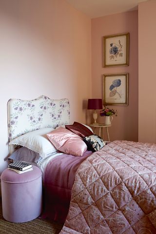Pink bedroom with floral headboard in a French bedroom