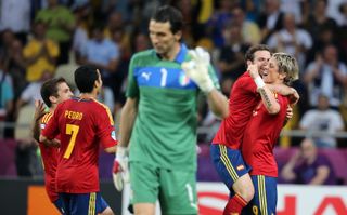 Italy goalkeeper Gianluigi Buffon looks dejected as Juan Mata and Fernando Torres celebrate a goal for Spain in the Euro 2012 final.