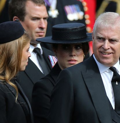Prince Andrew smiling at Princess Beatrice, with Princess Eugenie in a black veiled hat behind them