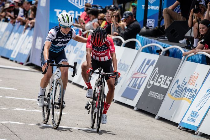 Trek-Segafredo's Ruth Winder helps rival Coryn Rivera (Team Sunweb) across the finish line after a mechanical problem on stage 3 of the 2019 Tour of California Women's Race