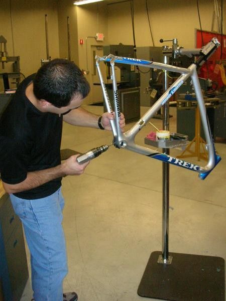 Trek's Mark Andrews drills a drain hole
