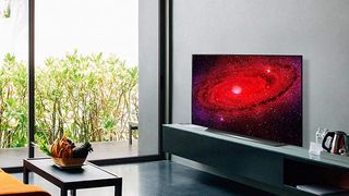 A press shot of an LG CX TV in a living room.