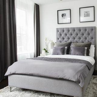 bedroom with grey curtains and white wall
