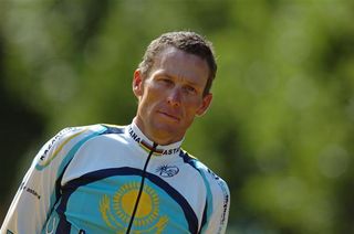 A new Tour experience for Lance Armstrong as he stands next to the top step of the podium