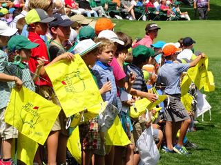 Young masters patrons wait patiently by the 9th green