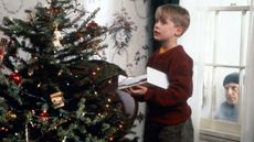 a still from the home alone movie with Kevin McAllister decorating the christmas tree
