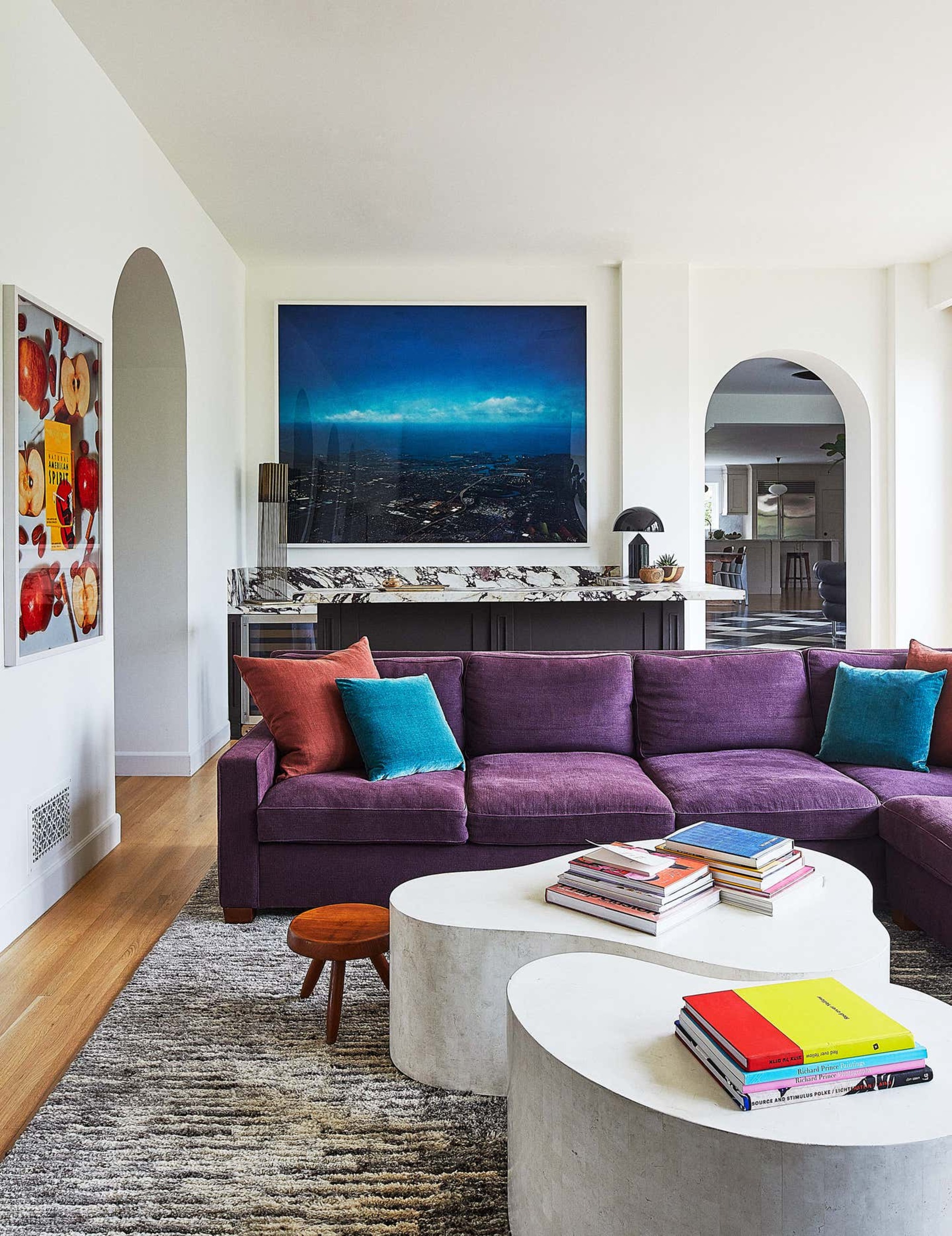 A purple sofa with blue cushions