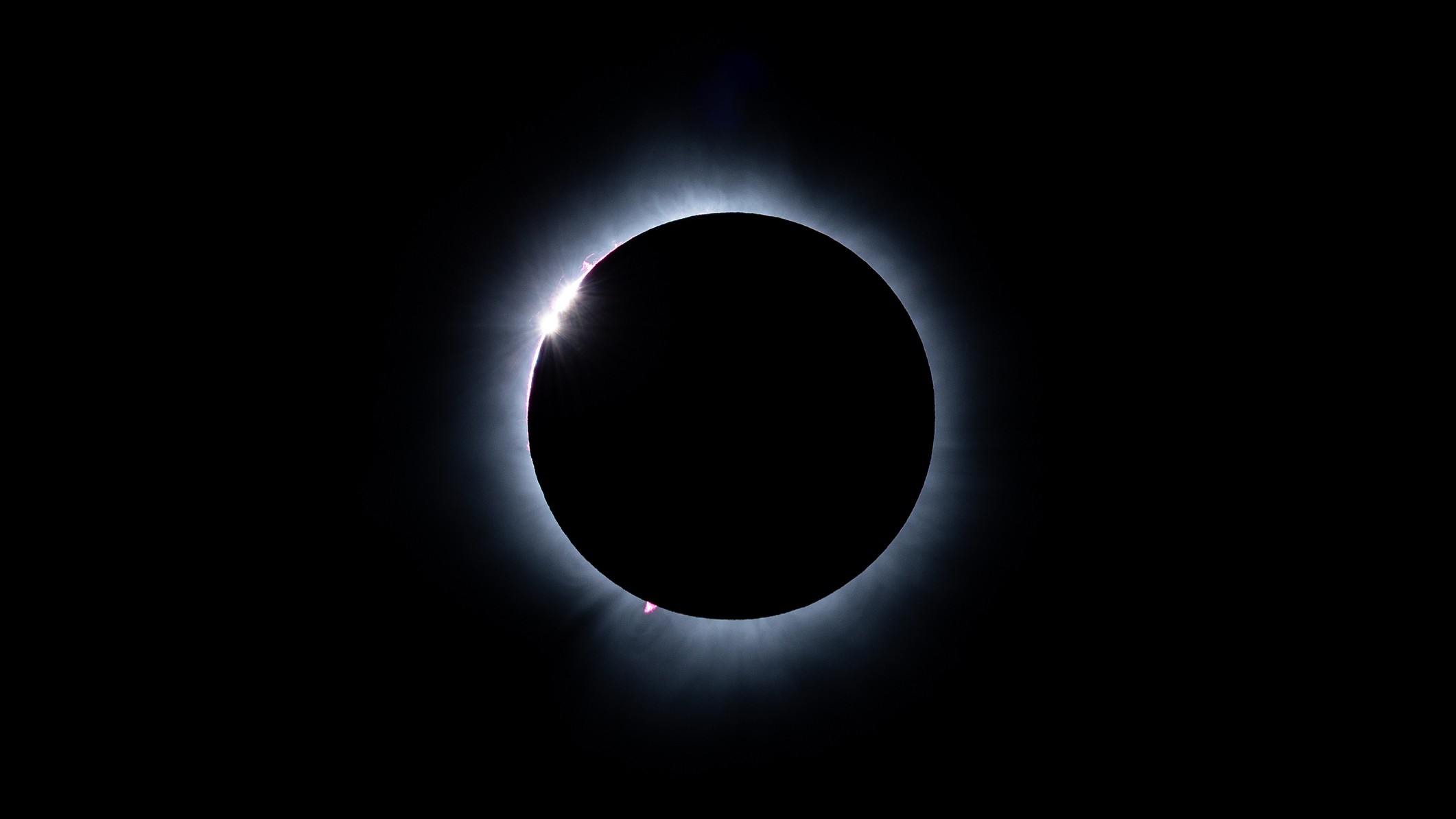 sun with the moon covering all but a tiny portion where light shines through in bead like formation - known as baily's beads.