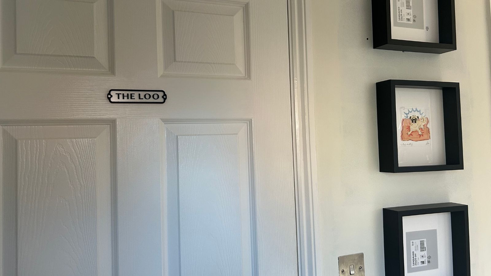 IKEA SANNAHED frames in entryway, in black