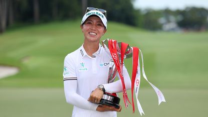 Lydia Ko holds the HSBC Women's World Championship trophy in her arms in 2025