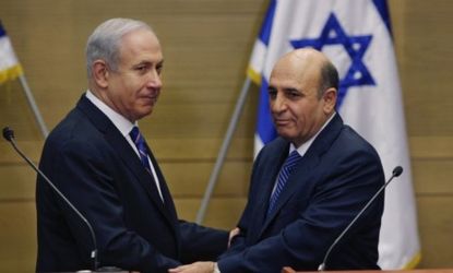 Israel's Prime Minister Benjamin Netanyahu, left, and Kadima party leader Shaul Mofaz shake hands before announcing the new coalition government in Jerusalem on May 8.