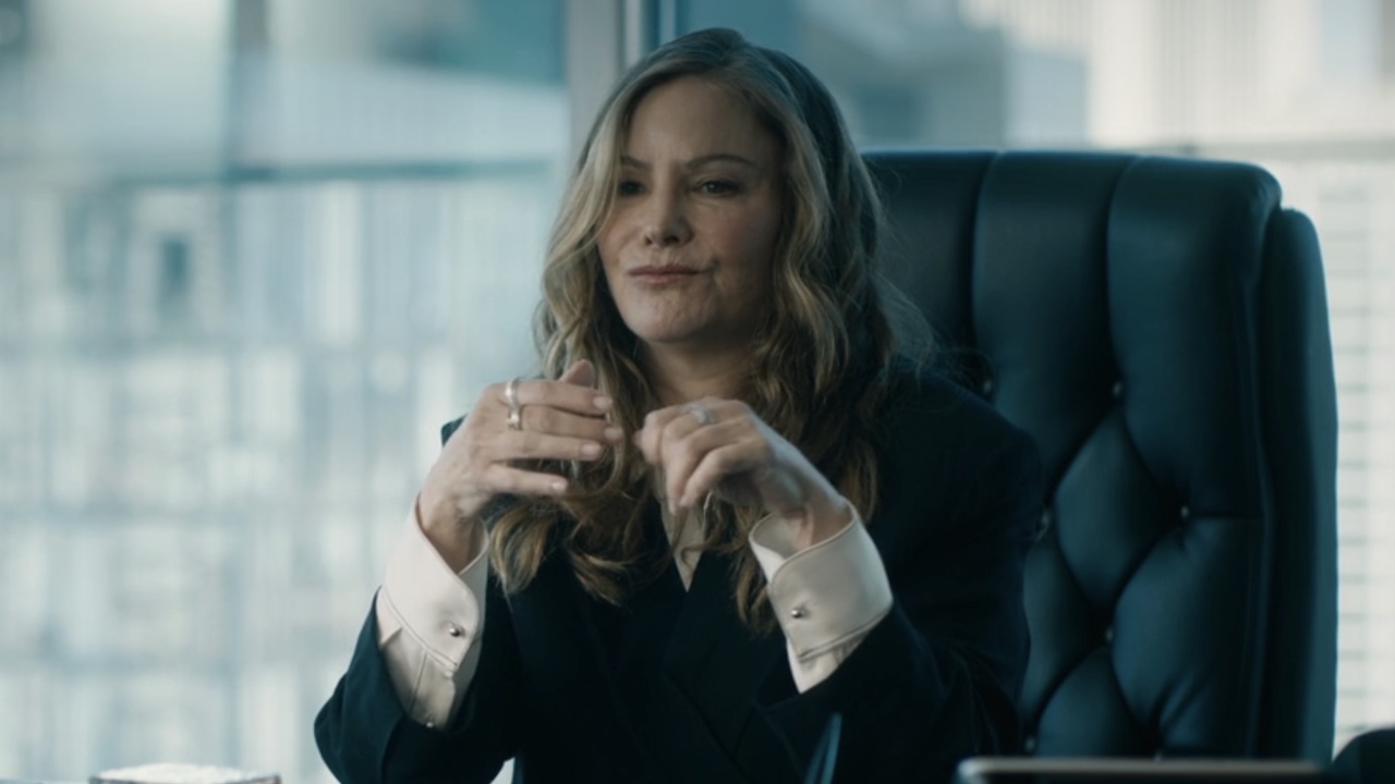 Willa pursing her lips sitting at her office desk talking to Soto in High Potential Season 2