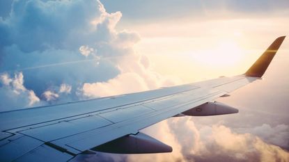 The wing of an airplane in the sky