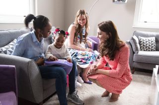 Britain's Catherine, Duchess of Cambridge (R), meets Kirsty Francois (L) and her 2 yr old daughter Teegan-Mia (2L) during a meeting with a parent support group while attending the launch of a series of films to raise awareness of maternal mental health challenges in London on March 23, 2017. Best Beginnings, a Charity Partner of the Heads Together campaign which is led by The Duke and Duchess of Cambridge and Prince Harry, has launched the 'Out of the Blue' film series which explores a range of mental health conditions from low mood and anxiety to more severe forms of depression.