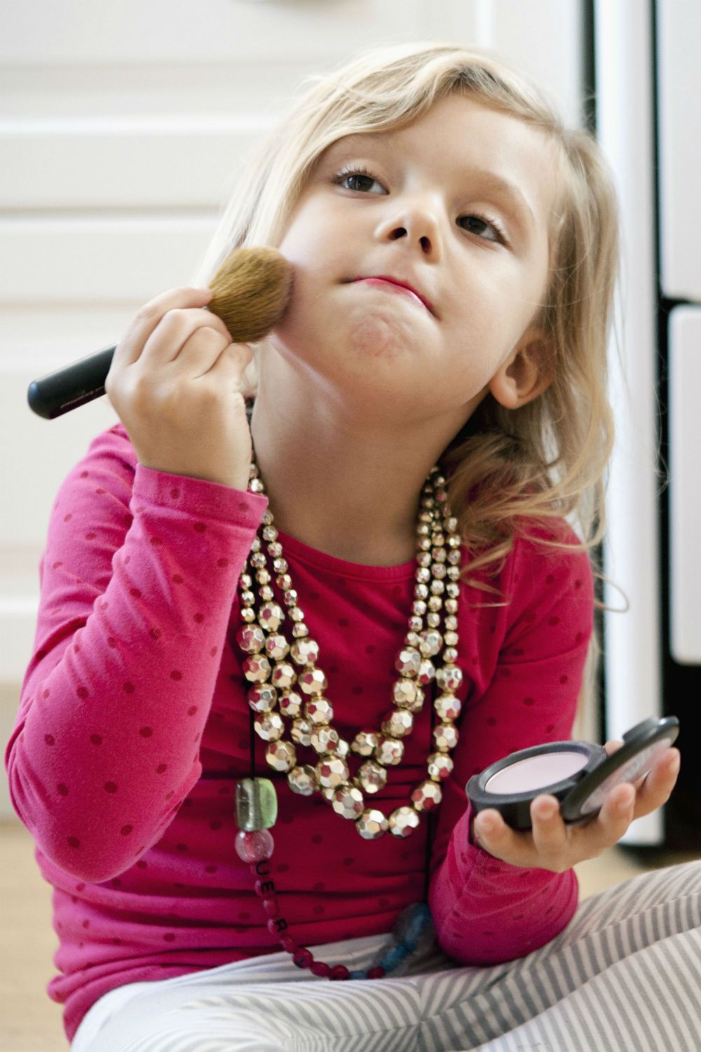 Young girls wearing makeup