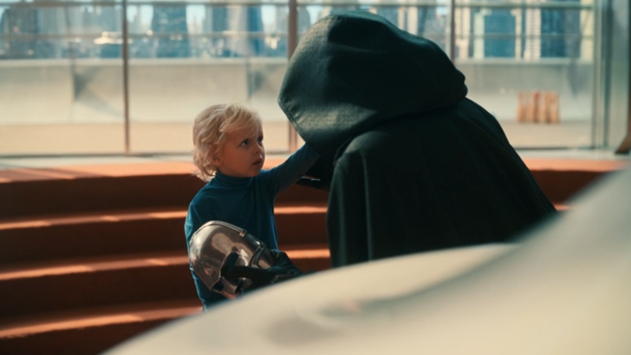 Franklin Richards reaching for Doctor Doom in The Fantastic Four: First Steps.