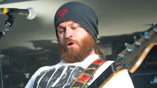 Dom Lawson playing bass onstage in 2014
