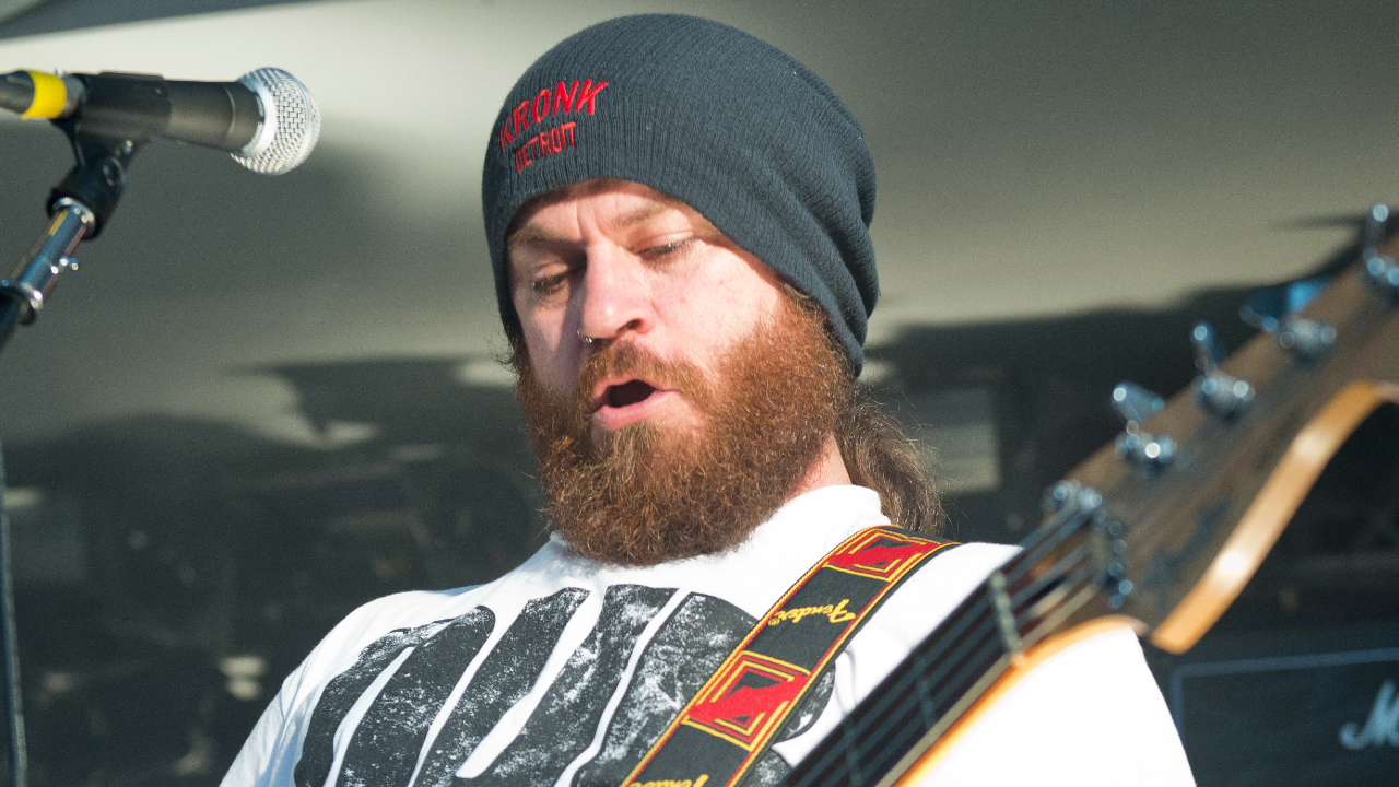 Dom Lawson playing bass onstage in 2014