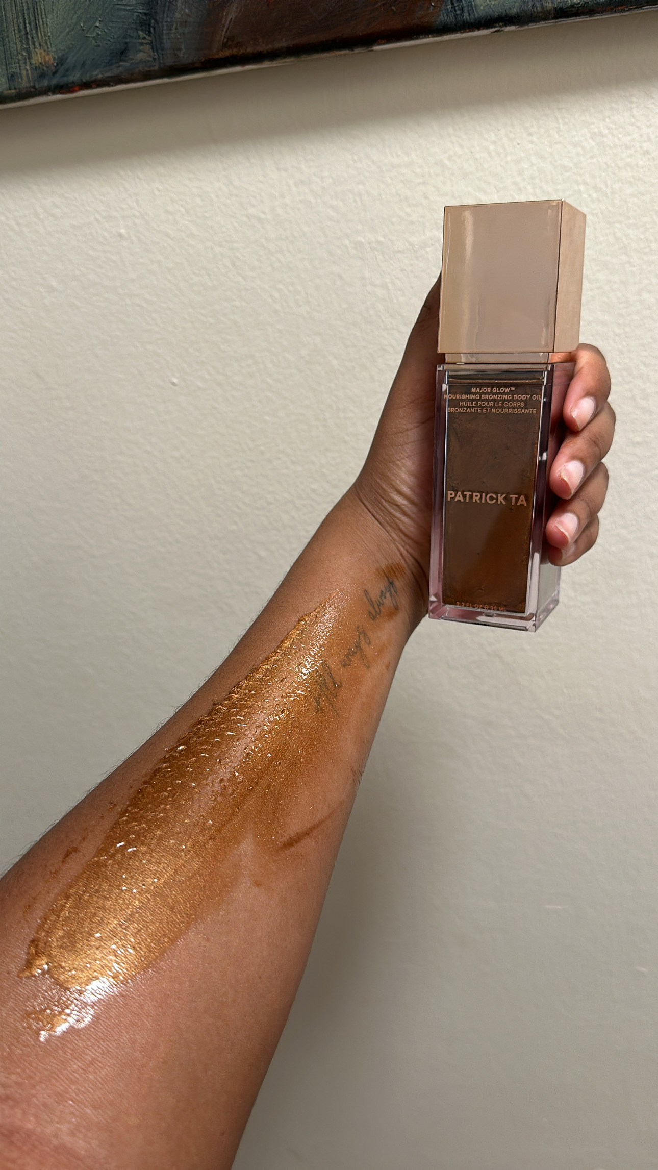 Ariel Baker testing the Patrick Ta Major Glow Nourishing Bronzing Body Oil.