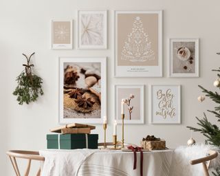 A gallery wall made up of various framed art prints and posters on wall above small round dining table