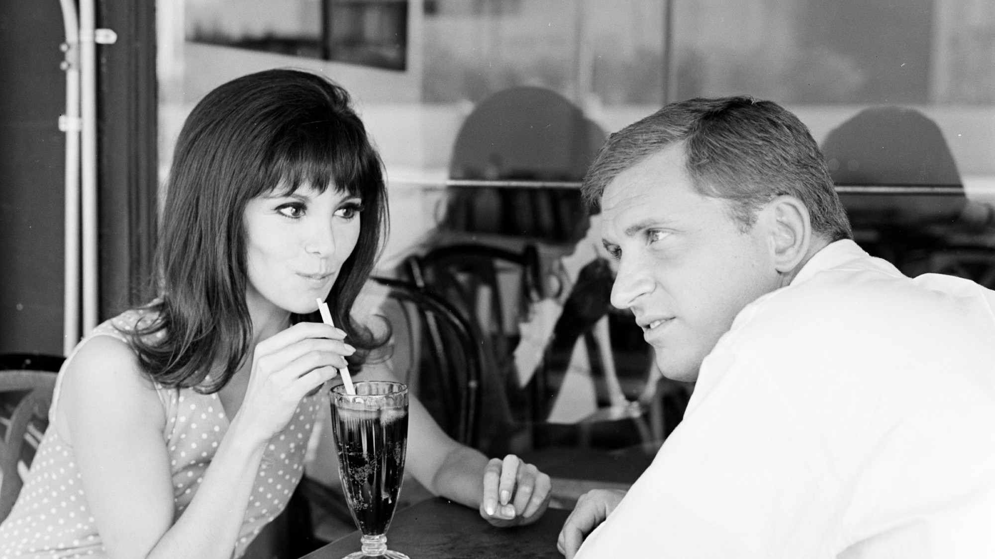 Marlo Thomas, in the TV show That Girl, drinking a soda with a straw alongside her TV boyfriend