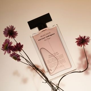 Narciso Rodriguez Musc Noir For Her Eau de Parfum floral perfume shot on a flower stem