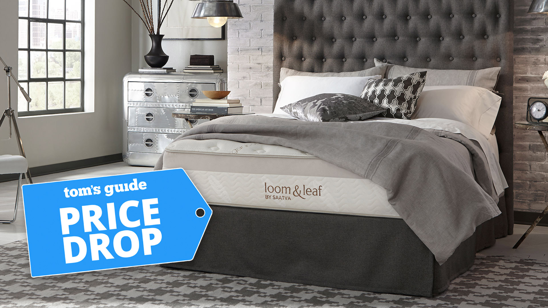 The Saatva Loom &amp; Leaf mattress on a bed in a stylish bedroom, with a Tom&#039;s Guide badge overlaid saying &#039;PRICE DROP&#039;